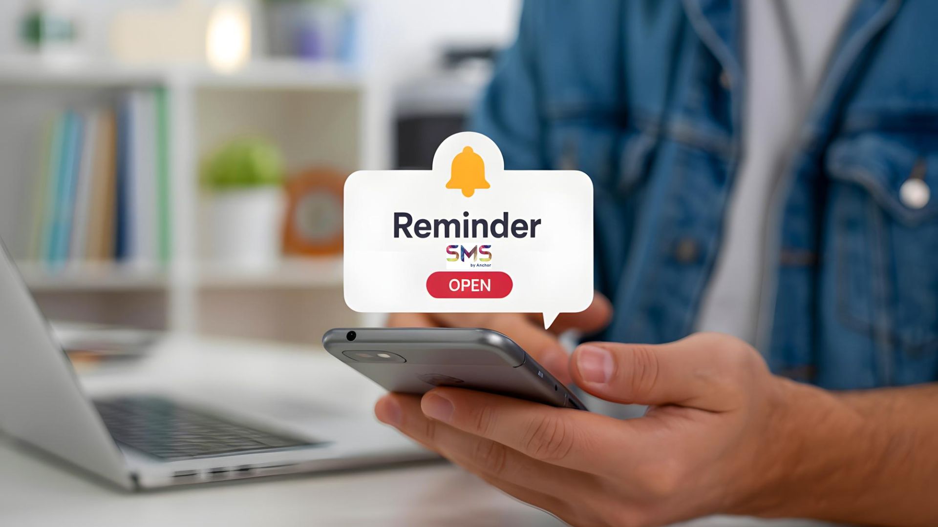 A person with jeans jacket holding a mobile phone with SMS reminder message notification (SMS by Anchor)